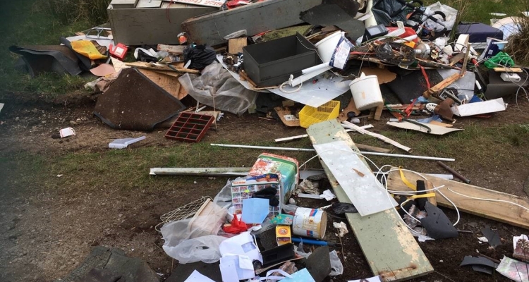 Large pile of flytipped rubbish on private land