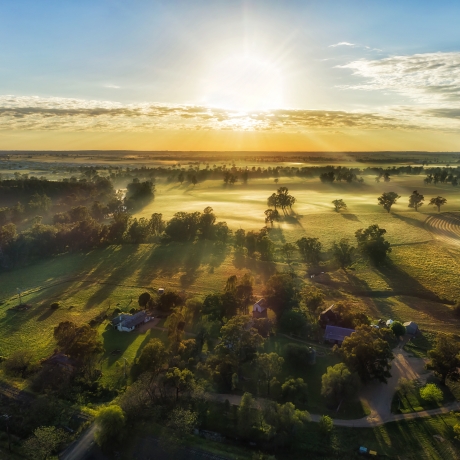 Sun rising over countryside